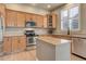 Spacious kitchen featuring wood cabinets, stainless steel appliances, an island, and neutral countertops at 3070 Redhaven Way, Highlands Ranch, CO 80126