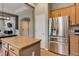Modern kitchen featuring stainless steel appliances, wood cabinets, and a center island at 3070 Redhaven Way, Highlands Ranch, CO 80126