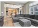 Spacious living room open to the kitchen, featuring hardwood floors and a comfortable grey sectional sofa at 3070 Redhaven Way, Highlands Ranch, CO 80126
