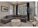 Bright living room with neutral colors, a sectional sofa, a chandelier, and shuttered windows at 3070 Redhaven Way, Highlands Ranch, CO 80126
