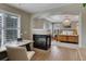 View from the office to main bedroom with tray ceiling, fireplace, large windows, and a chandelier at 3070 Redhaven Way, Highlands Ranch, CO 80126