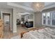 Bright main bedroom with a fireplace, chandelier, lots of windows, and a view to the attached office space at 3070 Redhaven Way, Highlands Ranch, CO 80126