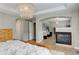 Spacious main bedroom boasts a fireplace, chandelier, and attached office space with lots of natural light at 3070 Redhaven Way, Highlands Ranch, CO 80126