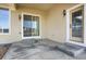 Back patio with sliding glass door, exterior light fixture, and access door at 5480 Craftsman Dr, Parker, CO 80134