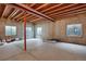 Unfinished basement with concrete floor, exposed ceiling and multiple windows at 5480 Craftsman Dr, Parker, CO 80134