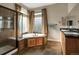 Luxurious bathroom with a jetted tub, a separate glass shower, and double sinks at 5480 Craftsman Dr, Parker, CO 80134