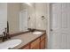 Bathroom featuring double sinks, white doors, and neutral walls at 5480 Craftsman Dr, Parker, CO 80134