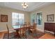 Inviting dining room featuring hardwood floors, elegant chandelier, and plenty of natural light at 5480 Craftsman Dr, Parker, CO 80134