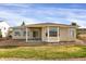 Back exterior view of home, with many windows and a covered patio at 5480 Craftsman Dr, Parker, CO 80134