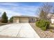 Attractive single-story home featuring a stone facade, an extra-wide driveway and a spacious two car garage at 5480 Craftsman Dr, Parker, CO 80134