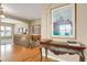 Foyer with hardwood floors, wood trim, an elegant console table, and staircase to the upper level at 5480 Craftsman Dr, Parker, CO 80134