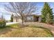 Charming single-story home featuring a stone facade, manicured landscaping, and an attached two car garage at 5480 Craftsman Dr, Parker, CO 80134