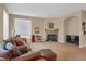 Inviting living room with a stone fireplace and large windows at 5480 Craftsman Dr, Parker, CO 80134