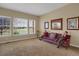 Bright living room featuring neutral walls, carpeted flooring, large windows, and decorative furnishings at 5480 Craftsman Dr, Parker, CO 80134
