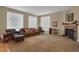 Spacious living room featuring hardwood floors, a stone fireplace, and plenty of natural light at 5480 Craftsman Dr, Parker, CO 80134