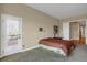 Comfortable main bedroom featuring a private door to the backyard at 5480 Craftsman Dr, Parker, CO 80134