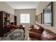 Office featuring a leather couch, desk, bookshelf, and artwork at 5480 Craftsman Dr, Parker, CO 80134
