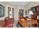 Office featuring a desk, leather chairs, bookshelf, and french doors at 5480 Craftsman Dr, Parker, CO 80134