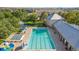 An aerial view features a large swimming pool, surrounded by lounge chairs and well-kept landscaping at 12760 Ironstone Way # 103, Parker, CO 80134