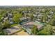 Aerial view of a community tennis and basketball courts surrounded by lush trees and well-maintained lawns at 12760 Ironstone Way # 103, Parker, CO 80134