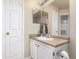 Neutral bathroom with a vanity, framed mirror and practical storage at 12760 Ironstone Way # 103, Parker, CO 80134