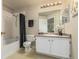 Bright bathroom featuring a shower-tub combo, neutral tiling, and a vanity with ample storage at 12760 Ironstone Way # 103, Parker, CO 80134