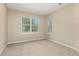 Comfortable bedroom featuring a large window with natural light, neutral walls and carpet flooring at 12760 Ironstone Way # 103, Parker, CO 80134