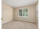 Light-filled bedroom featuring a large window, neutral walls and plush carpeting at 12760 Ironstone Way # 103, Parker, CO 80134