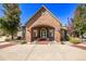 An inviting clubhouse with a brick archway, and double doors at 12760 Ironstone Way # 103, Parker, CO 80134