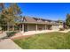 A long Clubhouse building featuring a covered patio and well manicured lawn at 12760 Ironstone Way # 103, Parker, CO 80134