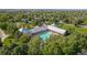 An aerial shot of a community pool and recreation center surrounded by mature trees at 12760 Ironstone Way # 103, Parker, CO 80134