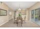 Dining room with a glass table, seating for four, carpeted floors and sliding doors to the outside at 12760 Ironstone Way # 103, Parker, CO 80134