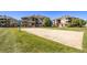 Sand volleyball pit on a grassy area with residential buildings in the background on a sunny day at 12760 Ironstone Way # 103, Parker, CO 80134