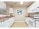 Spacious kitchen featuring white appliances, ample counter space, and an open design for easy meal preparation at 12760 Ironstone Way # 103, Parker, CO 80134