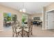 Cozy living and dining area with neutral tones, a glass dining table, and sliding door access to the outside at 12760 Ironstone Way # 103, Parker, CO 80134