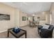 Spacious living room featuring a sofa, armchair, dining area and abundant natural light at 12760 Ironstone Way # 103, Parker, CO 80134