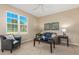 Inviting living room featuring a comfortable armchair, sofa, and large window for natural light and beautiful decor at 12760 Ironstone Way # 103, Parker, CO 80134