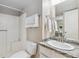 Cozy bathroom with granite countertop, sink and white shower with sliding curtain at 8331 S Upham Way # 101, Littleton, CO 80128