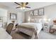 Comfortable bedroom with a decorative ceiling fan, neutral colors, and stylish decor at 8331 S Upham Way # 101, Littleton, CO 80128