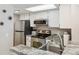 Modern kitchen with stainless steel appliances, granite countertops, and ample cabinet space at 8331 S Upham Way # 101, Littleton, CO 80128
