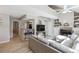 Bright living room features light wood floors, fireplace, and neutral color scheme for a modern, inviting space at 8331 S Upham Way # 101, Littleton, CO 80128