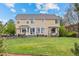 Large, well-maintained backyard with a covered patio and dining area, providing a great space for relaxation at 5791 Chisholm Pl, Parker, CO 80134