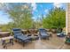 Outdoor patio featuring fountain, lounge chairs, trees, and blue skies at 5791 Chisholm Pl, Parker, CO 80134