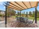 Backyard patio with awning, dining table, and seating for many guests at 5791 Chisholm Pl, Parker, CO 80134