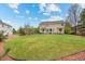 Expansive backyard featuring a lush lawn, a patio area, and mature trees, ideal for outdoor activities at 5791 Chisholm Pl, Parker, CO 80134