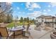 Spacious backyard featuring a cozy stone fire pit and outdoor dining area perfect for entertaining at 5791 Chisholm Pl, Parker, CO 80134