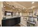 Finished basement featuring a kitchenette, exercise equipment, and a movie theater space at 5791 Chisholm Pl, Parker, CO 80134