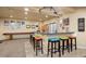 Finished basement with bar seating, pool table, unique decorations, and track lighting at 5791 Chisholm Pl, Parker, CO 80134
