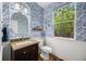Charming powder room boasts wallpaper, wainscoting, wood floors, and a vanity with granite countertop at 5791 Chisholm Pl, Parker, CO 80134