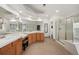 Bright bathroom features dual sinks, vanity, walk-in glass shower, and tile flooring at 5791 Chisholm Pl, Parker, CO 80134